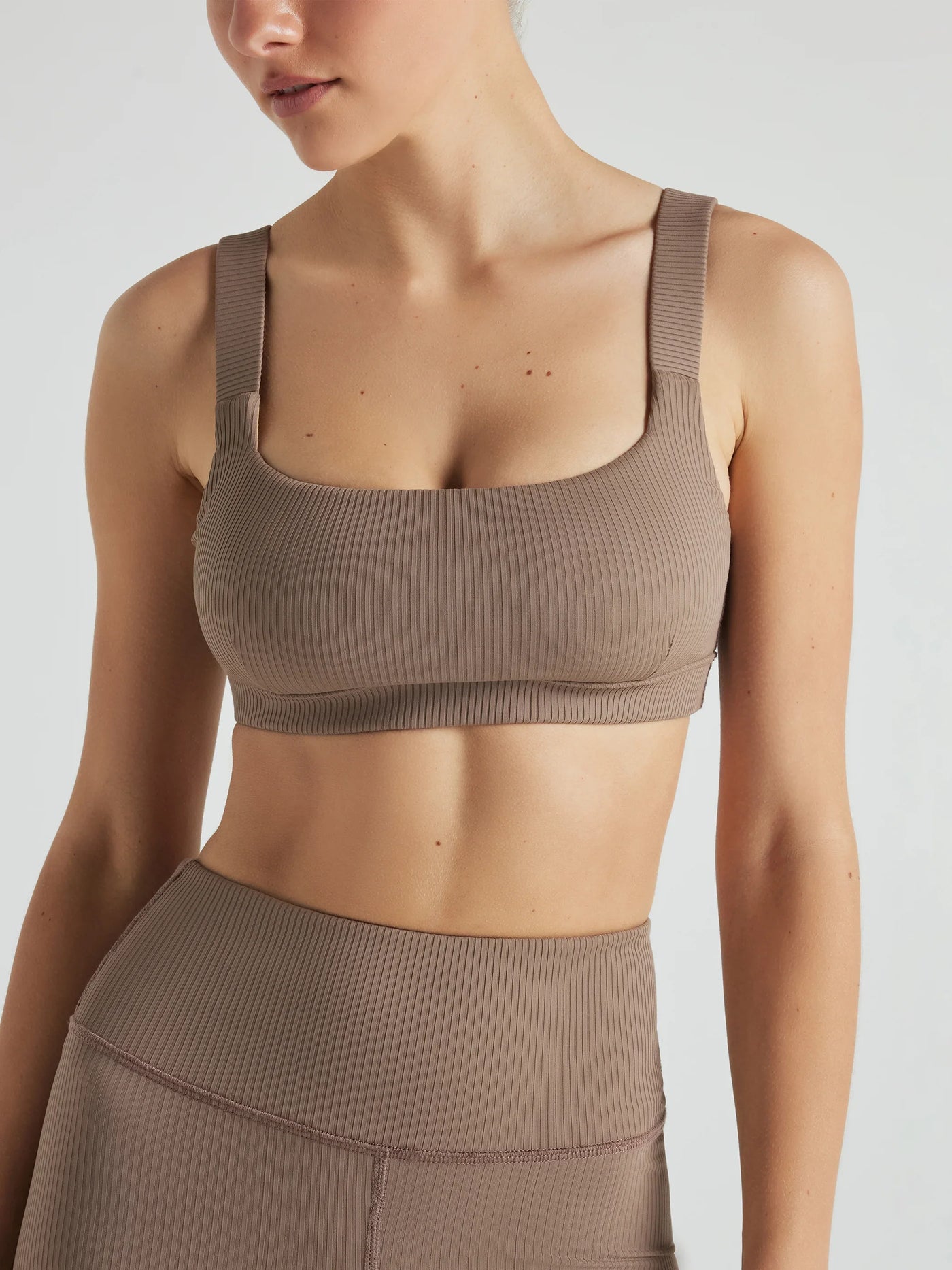 Model wears sustainable square neck light brown nylon rib sports bra