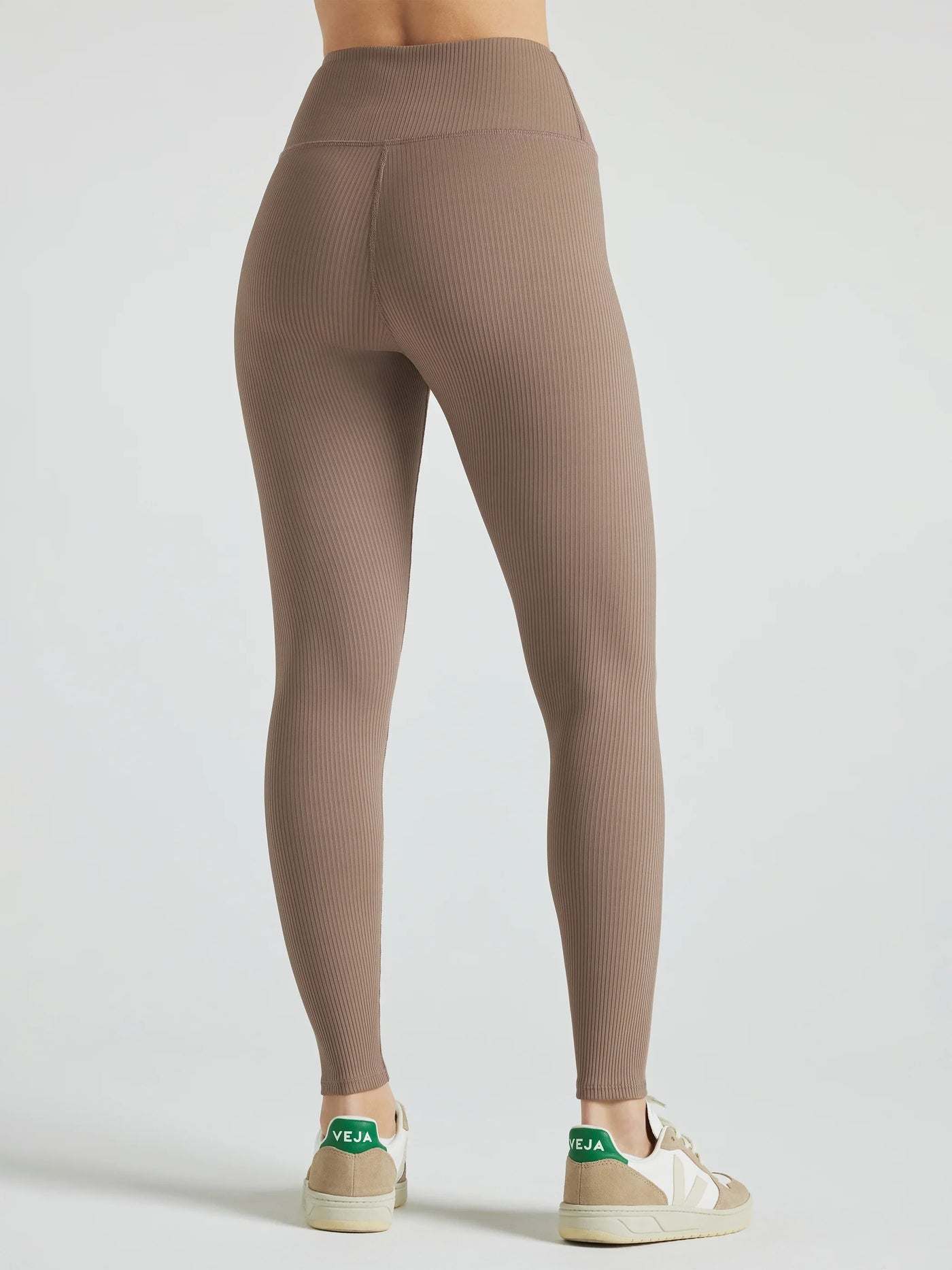 Model wears sustainable light brown nylon rib leggings