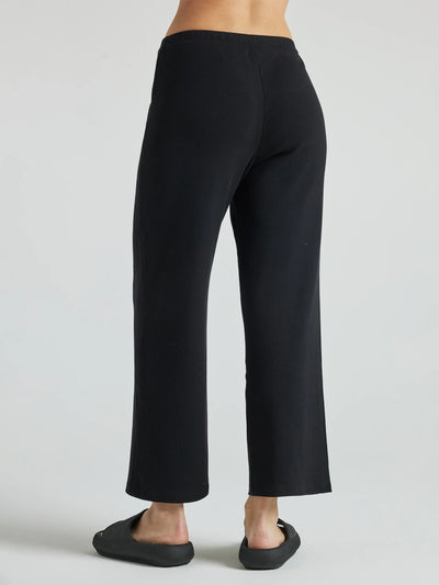 model wears black wide leg relaxed rib cropped pant