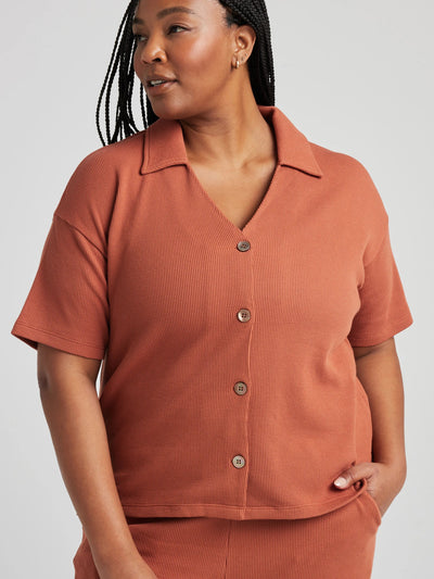 model poses in orange thermal button down with seashell buttons