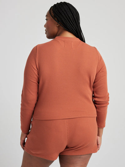 model wears organic thermal long sleeve in orange