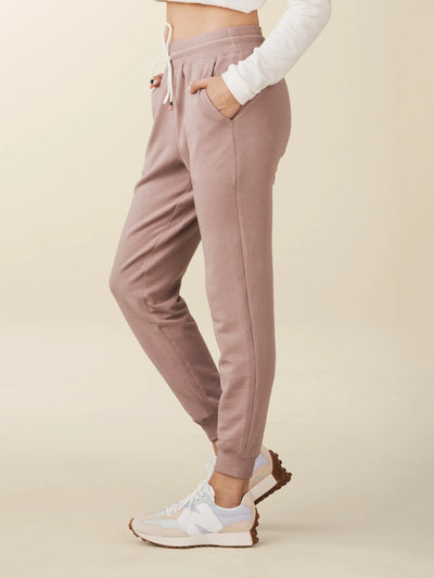 model wears cozy sustainable joggers with pockets in blush