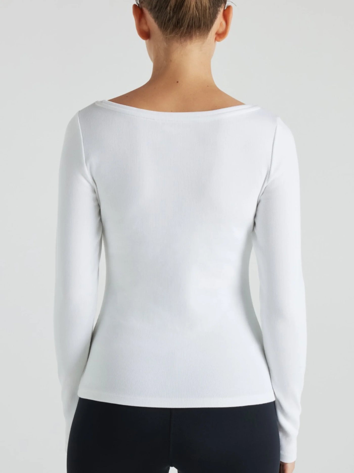 model wears white boat neck long sleeve