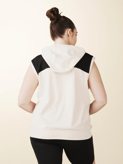 model wears cream colorblock sleeveless hoodie