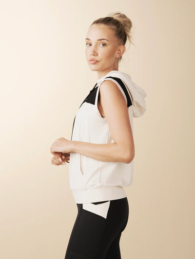 model wears cream colorblock sleeveless hoodie