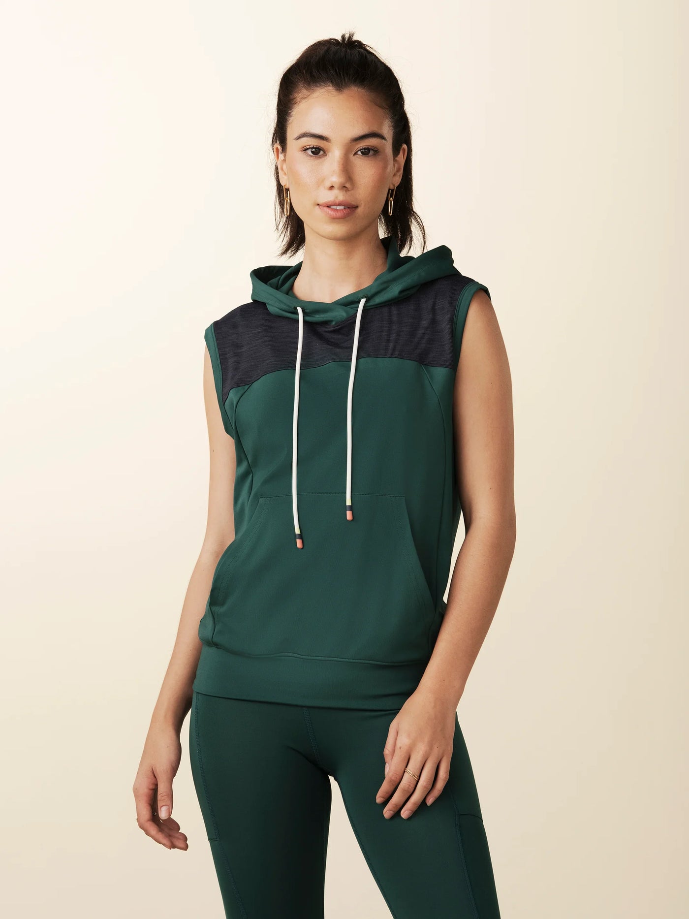 model wears green colorblock sleeveless hoodie